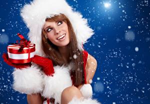 Wallpaper Christmas Present Glance Smile Brunette girl Face Winter hat Brown haired young woman